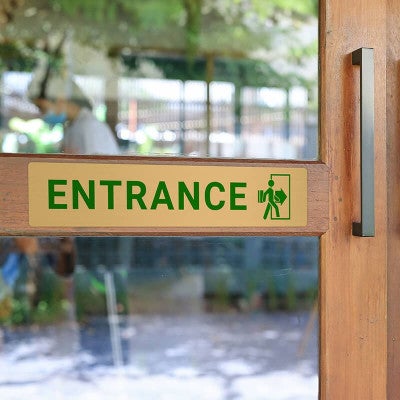 2x10 printed brass sign displayed on a front door