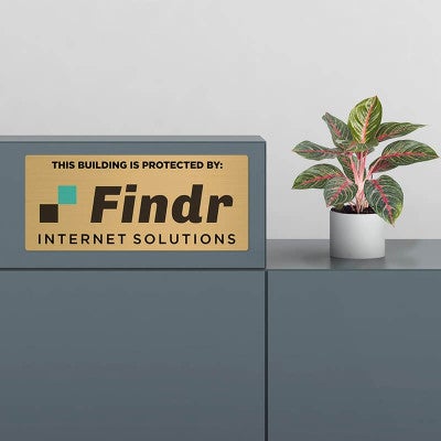 6x14 printed brass sign displayed by a desk