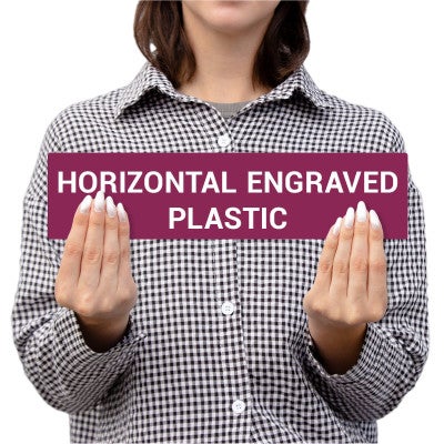 Person Holding A Horizontal Engraved Plastic Sign