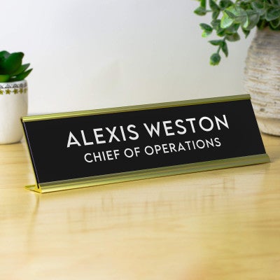 Alexis Watson in Refined Minimalist Style, Black With White Letters Desk Plate on Clean Office Table