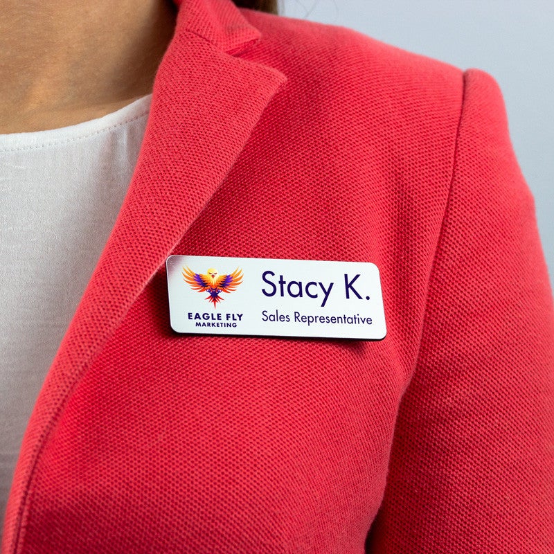 White name tag - sales representative - worn on a pink blazer for perspective