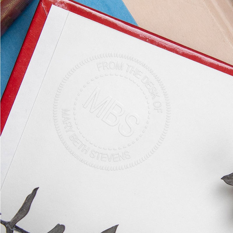 Example of custom Initial Embosser impression on the inside of a book