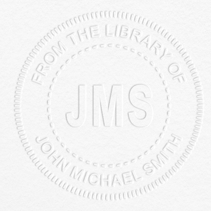 Example of From the Library Initials Personalized Book Embosser Imprint on grey paper