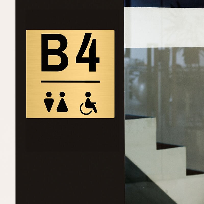 8x8 custom engraved brass sign displayed by stairs