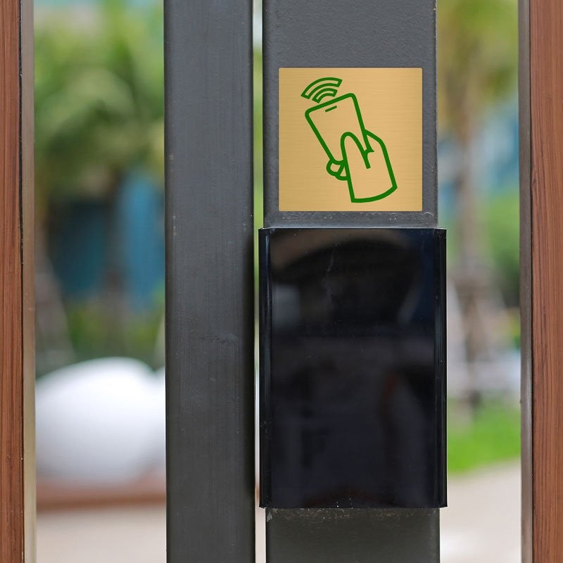 Custom printed brass sign with a green icon