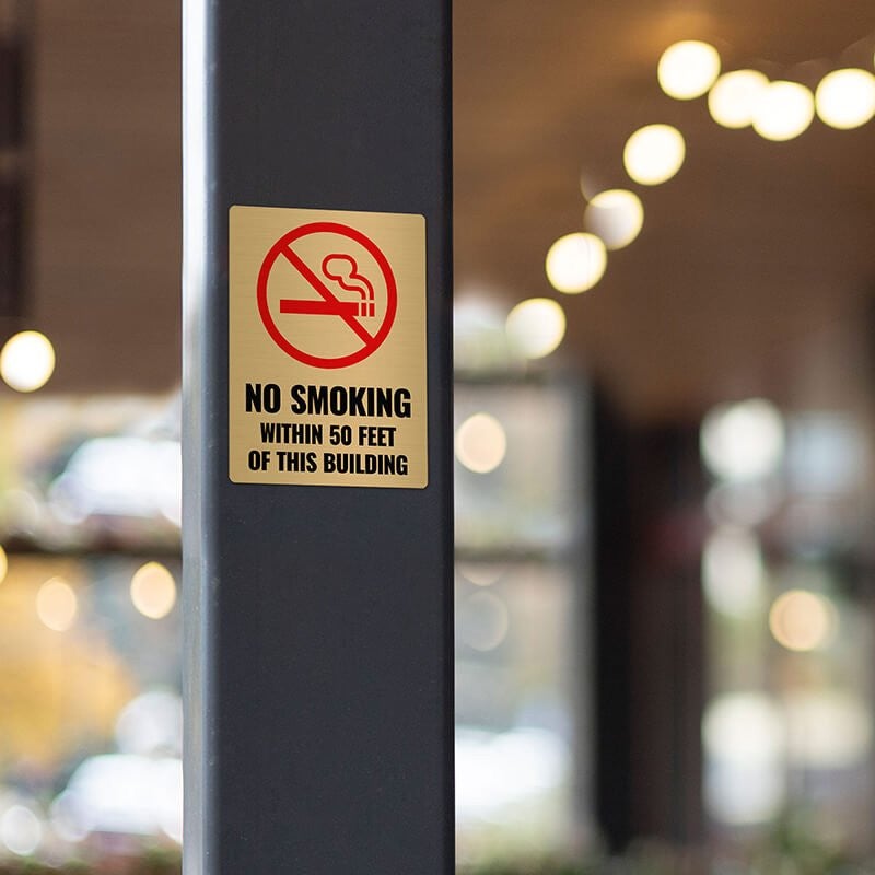4x3 printed brass sign displayed on a pillar