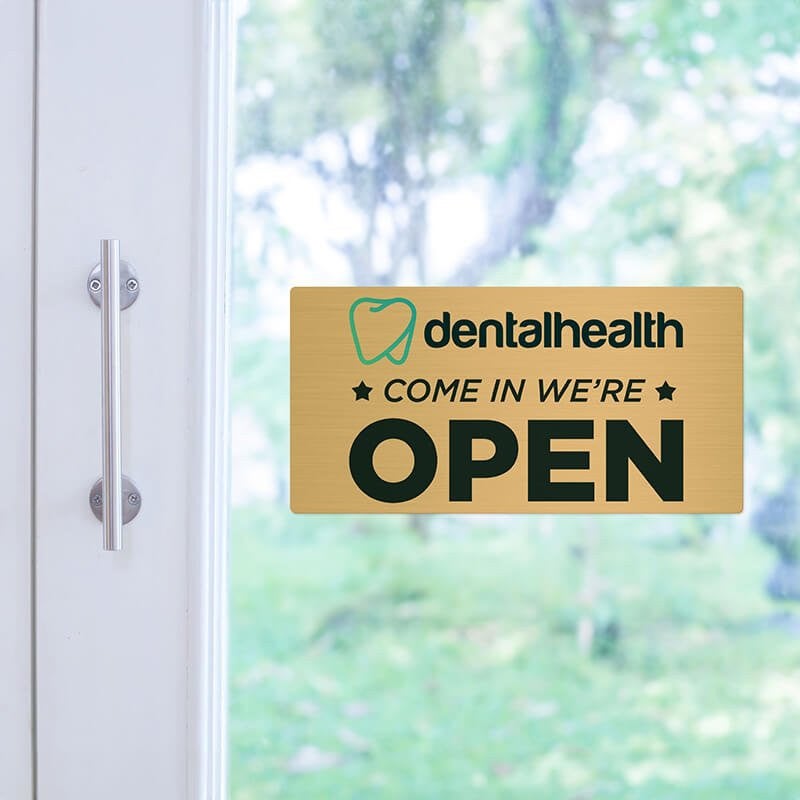 4x8 printed brass sign displayed on a glass door