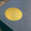 Example of Custom Initial Embosser Impression on Gold seal sticker on blue book