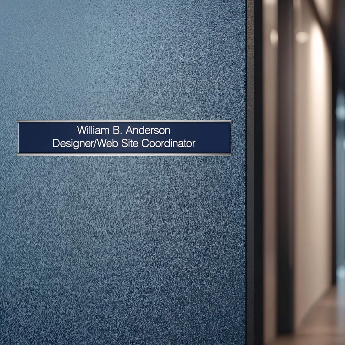 A blue name plate with a silver aluminum wall holder on an office door