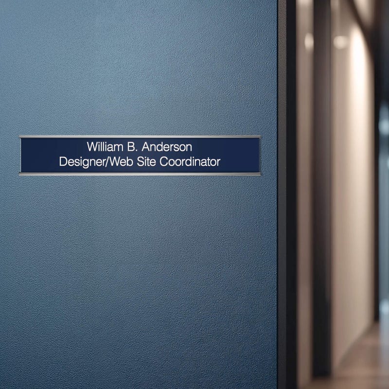 A blue name plate with a silver aluminum wall holder on an office door
