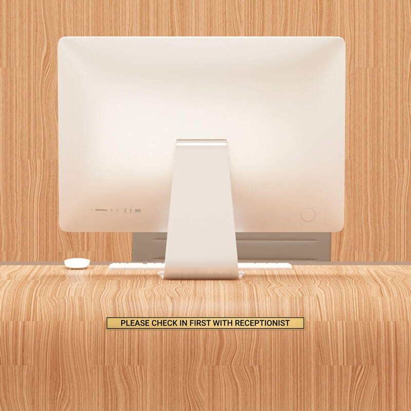 1x16 custom engraved brass sign displayed on a desk