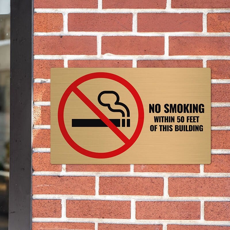 12x20 printed brass sign displayed on a brick wall