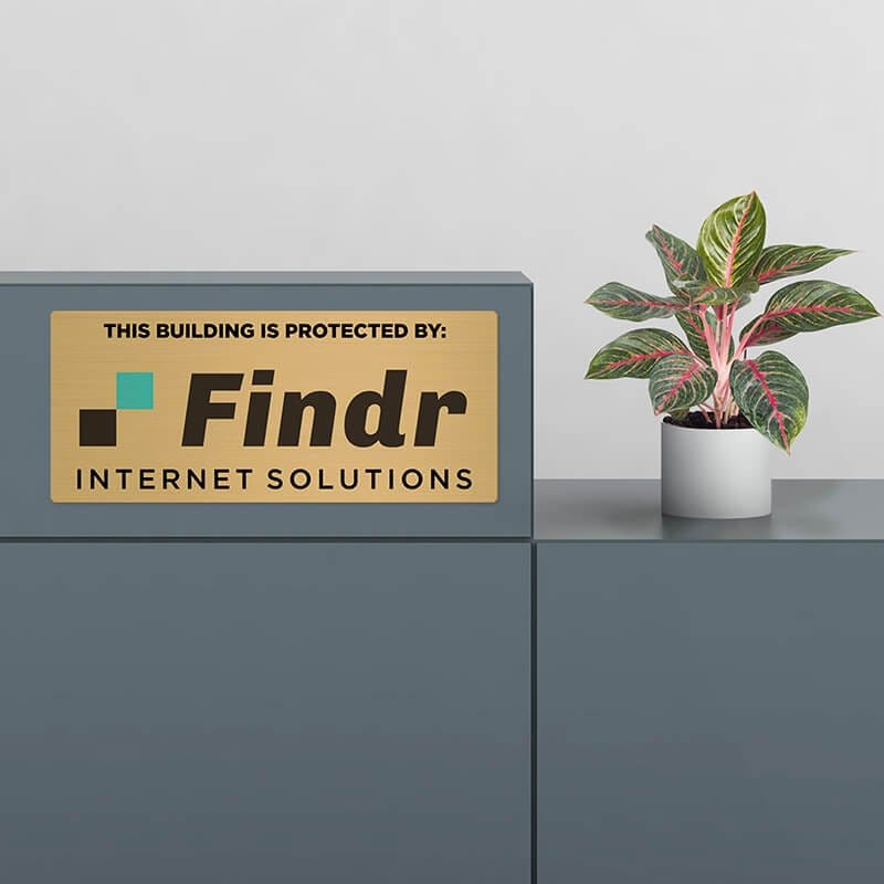 6x14 printed brass sign displayed by a desk