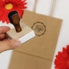 An example of a hand holding a custom logo stamp