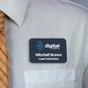 Dark blue full-color name tag - lead technician - worn on a light dress shirt for size perspective