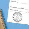 Texas architect stamps impression on official document with custom seal design.  