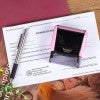 New Mexico Pink Rectangle Notary Stamp Laying Next to an Impression on a Document