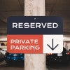 Custom reserved private parking sign with navy, red and white background with downward-pointing arrow