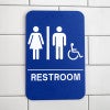 Blue Unisex Handicap Sign Hanging on a Wall