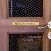 1x8 custom engraved brass sign displayed on a door