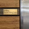 8x20 custom engraved brass sign displayed by an elevator