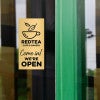 6x3 custom engraved brass sign displayed on a window