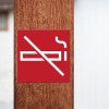 A red square engraved plastic sign with a no smoking symbol