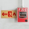 3x6 printed brass sign next to a fire alarm