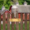 2 By 8 Brass Plate On A Picket Fence In Front Of A Barn Saying Twin Oaks, Established 2018