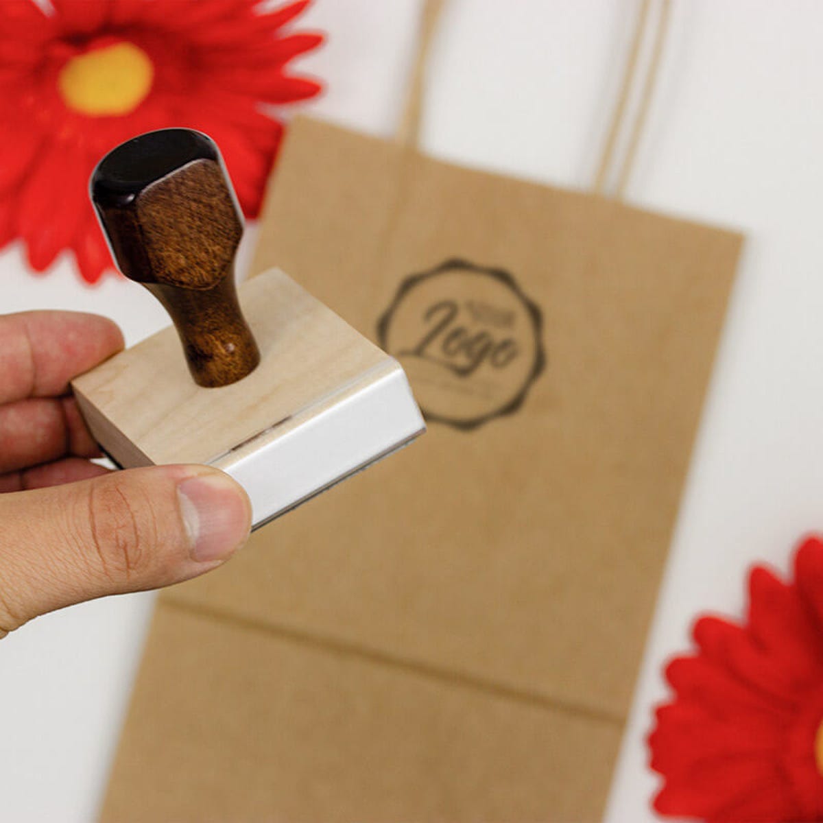 An example of a hand holding a custom logo stamp